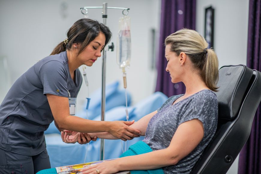 Nurse helping patient with IV